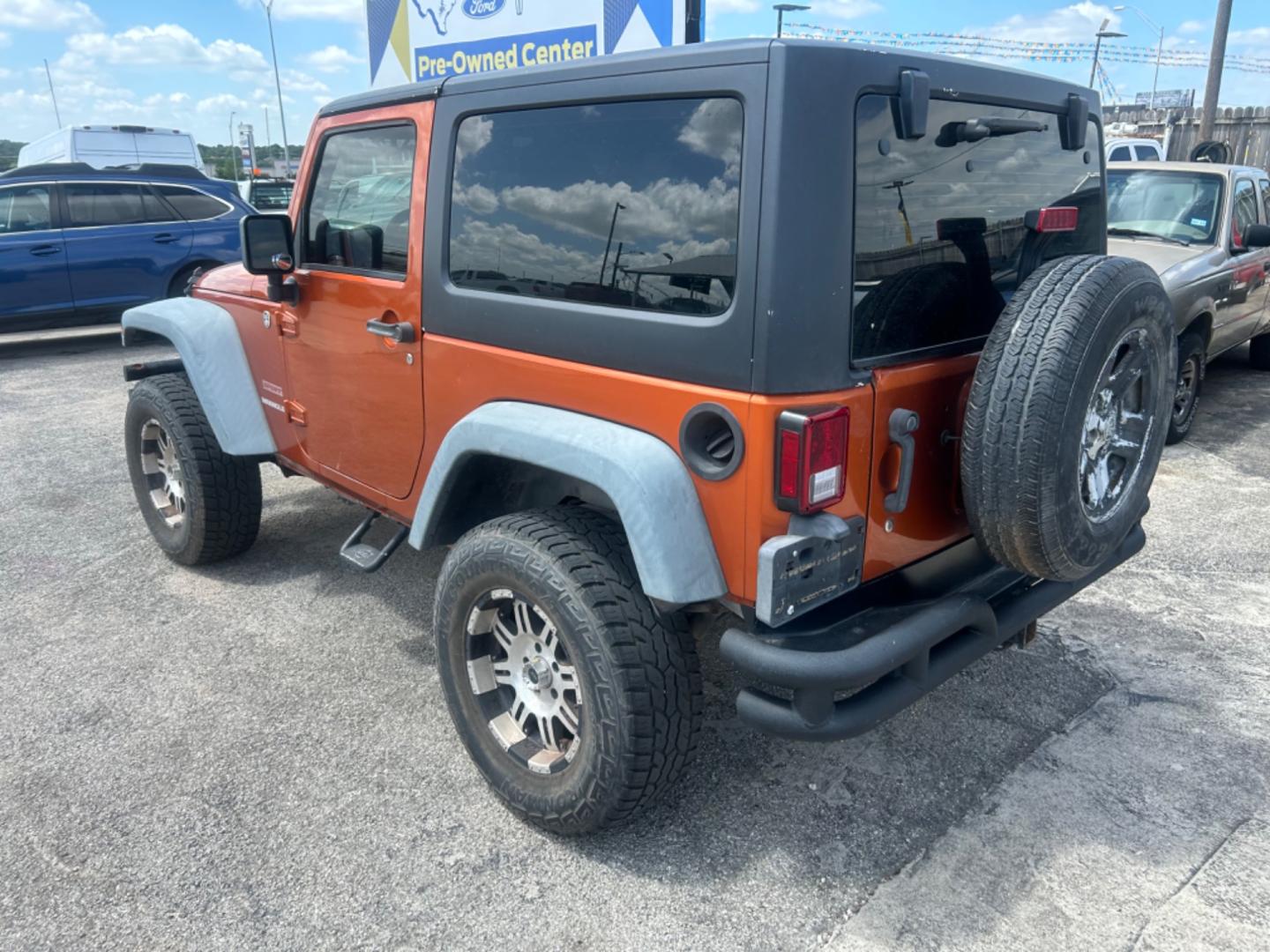 2011 Orange Jeep Wrangler Sport 4WD (1J4AA2D18BL) with an 3.8L V6 OHV 12V engine, Automatic transmission, located at 1687 Business 35 S, New Braunfels, TX, 78130, (830) 625-7159, 29.655487, -98.051491 - Photo#1