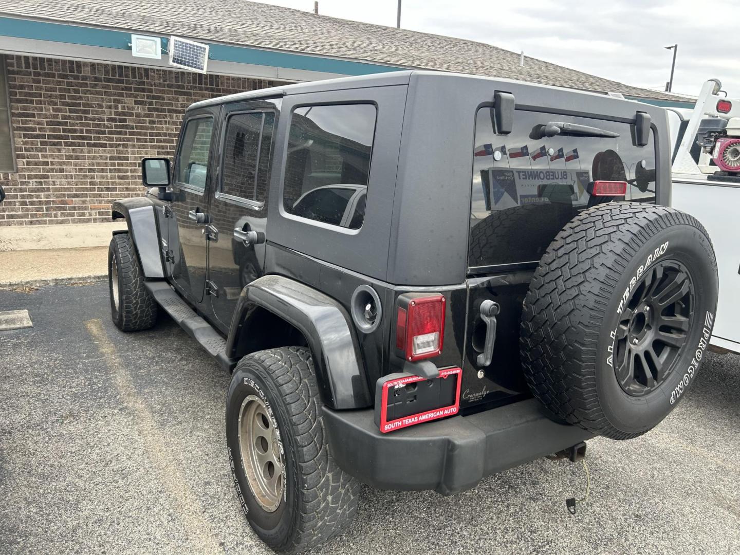 2007 Black Jeep Wrangler Unlimited Sahara 4WD (1J4GA59187L) with an 3.8L V6 OHV 12V engine, located at 1687 Business 35 S, New Braunfels, TX, 78130, (830) 625-7159, 29.655487, -98.051491 - Photo#1