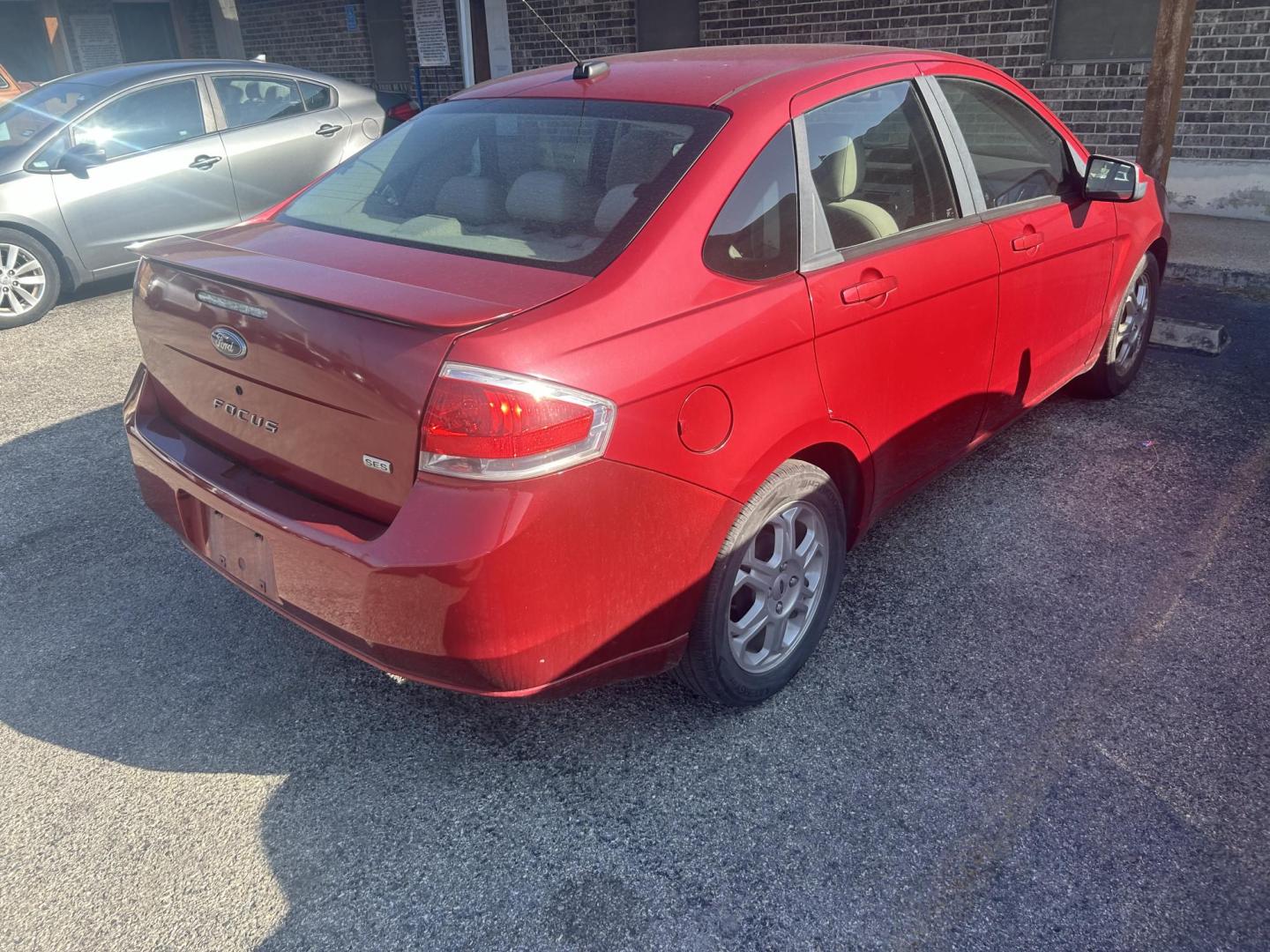 2009 Red Ford Focus SES Sedan (1FAHP36N39W) with an 2.0L L4 DOHC 16V engine, located at 1687 Business 35 S, New Braunfels, TX, 78130, (830) 625-7159, 29.655487, -98.051491 - Photo#2