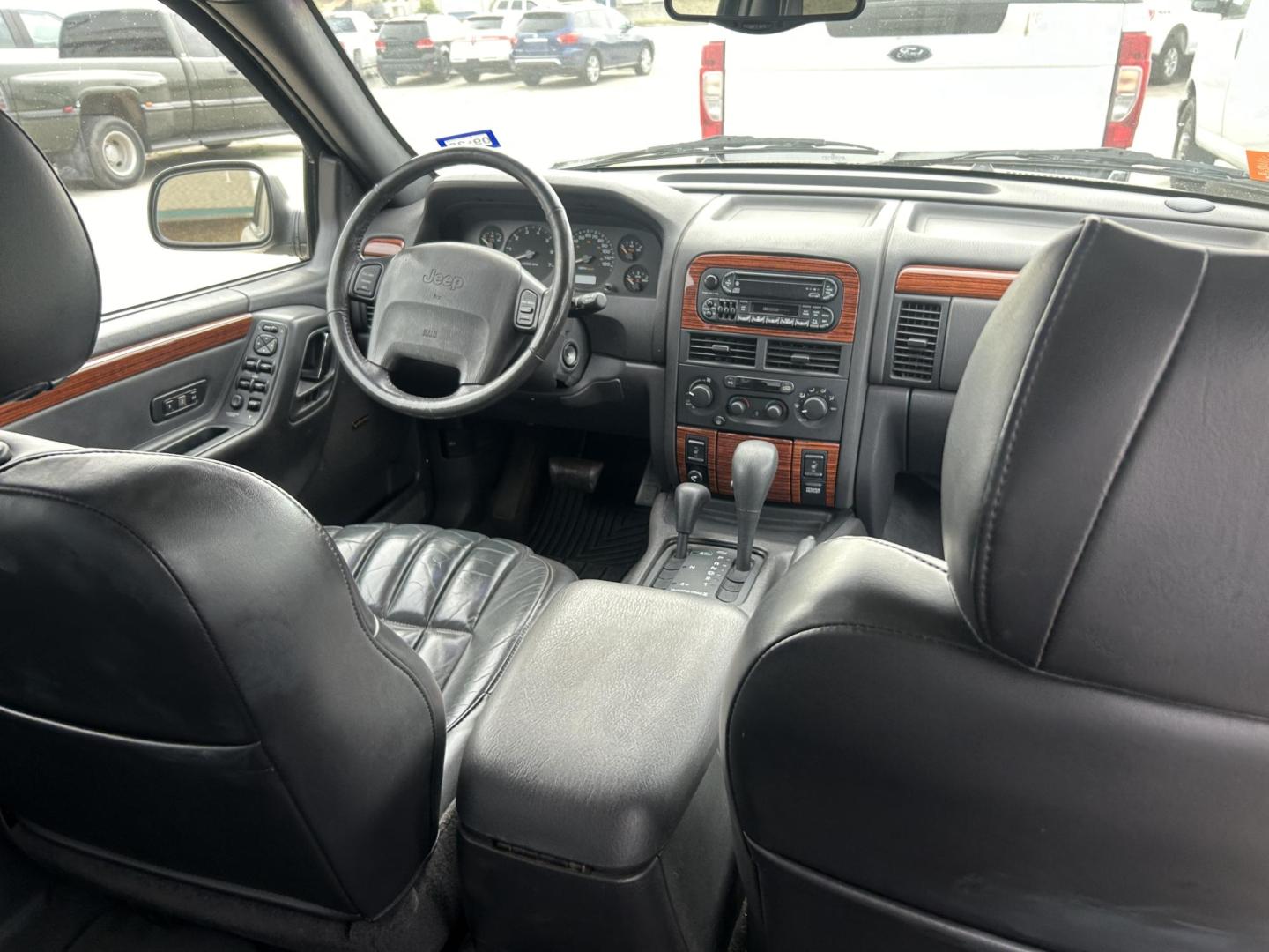 1999 Black Jeep Grand Cherokee Limited 4WD (1J4GW68NXXC) with an 4.7L V8 SOHC 16V engine, 4-Speed Automatic Overdrive transmission, located at 1687 Business 35 S, New Braunfels, TX, 78130, (830) 625-7159, 29.655487, -98.051491 - Photo#5